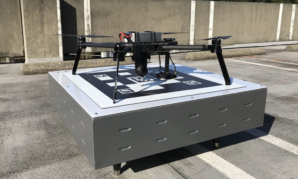 Drone Outfitted with WiBotic’s OC-251 Onboard Charger, Sitting Atop a WiBotic PowerPad (TR-301 Transmitter in an Enclosure)